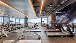 A modern gym with treadmills, dumbbells, and weight benches. - Modern 1-bed in Hip Southbank With Pool & Gym (Melbourne)