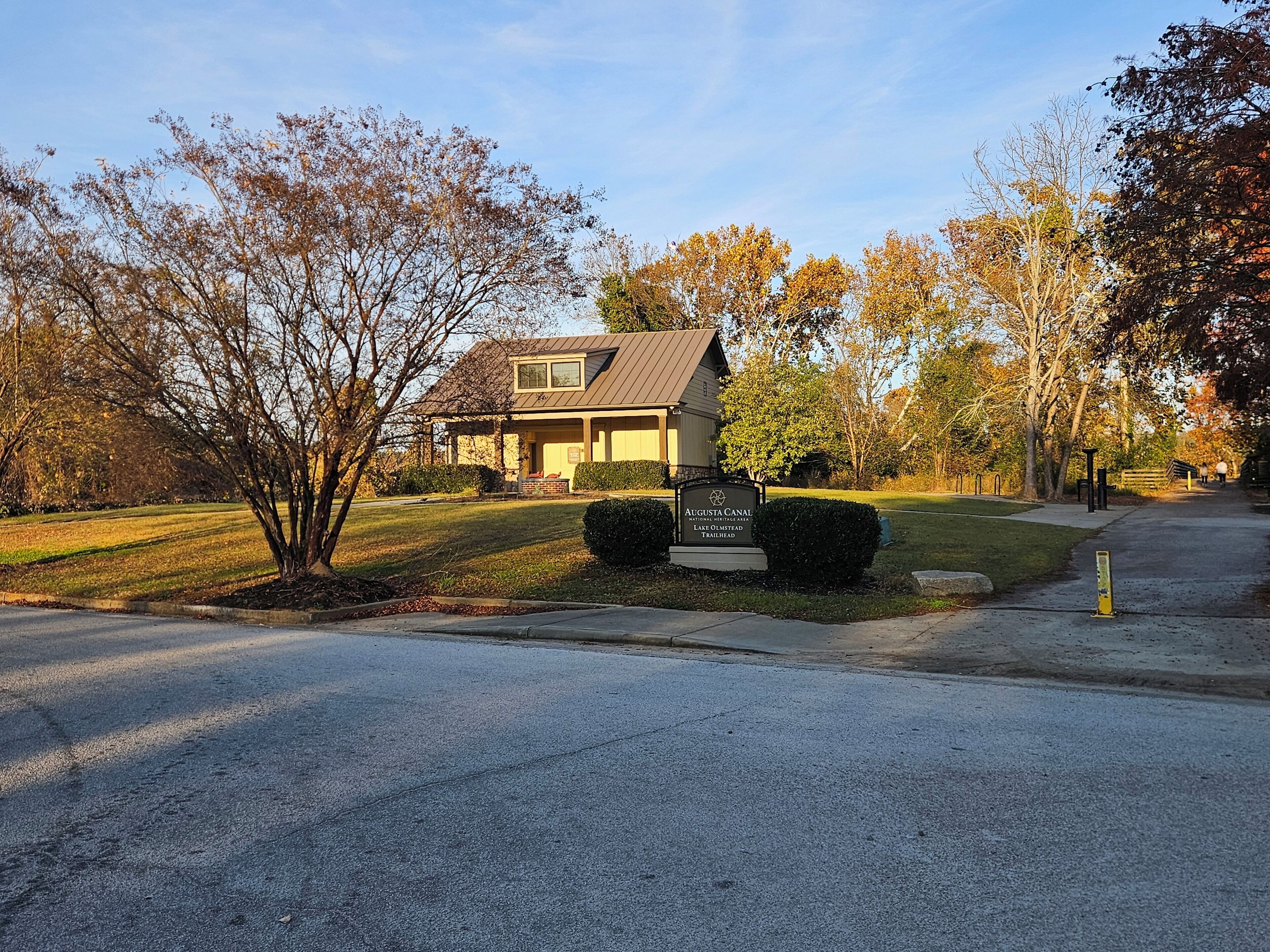 A two-story house with a front lawn and a paved driveway.