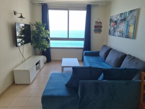 Family Apartment, Ocean View | Living area | Flat-screen TV - Sea Tower Almog (Haifa)