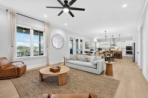 Open Floor Plan - The great room flows into the kitchen and dining area, with light oak floors, high ceilings, and views of the lake. - Lakefront Lake Anna - Decks, Views, Hot Tub (Louisa County)