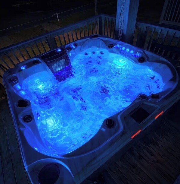 A hot tub with a wooden deck surrounding it. - Pirate's Bay. New build! Pets! Hot Tub! Affordable! Views of Ocean AND Bay! (Surfside Beach)