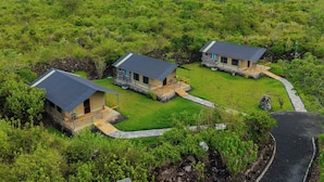 A remote eco-lodge with three stone buildings, each with a flat roof and a small porch. - Sleeping Warrior Camp Elementaita (Gilgil)
