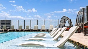 A swimming pool with lounge chairs and a view of a cityscape. - Walk to the 2026 FIFA games! (Atlanta)