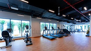 A gym with treadmills, elliptical machines, and weight stations. - Luxury Hostel Bedspace in Downtown (Dubai)