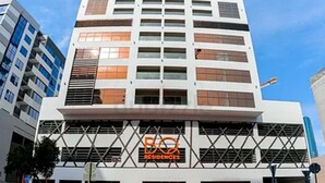 A modern multi-story building with a prominent 'RESIDENCES' sign. - Luxury Hostel Bedspace in Downtown (Dubai)
