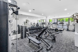 A modern gym with various exercise equipment, including dumbbells, treadmills, and weight machines. - City Centre Living Meets Comfort by Zodiak (Auckland)