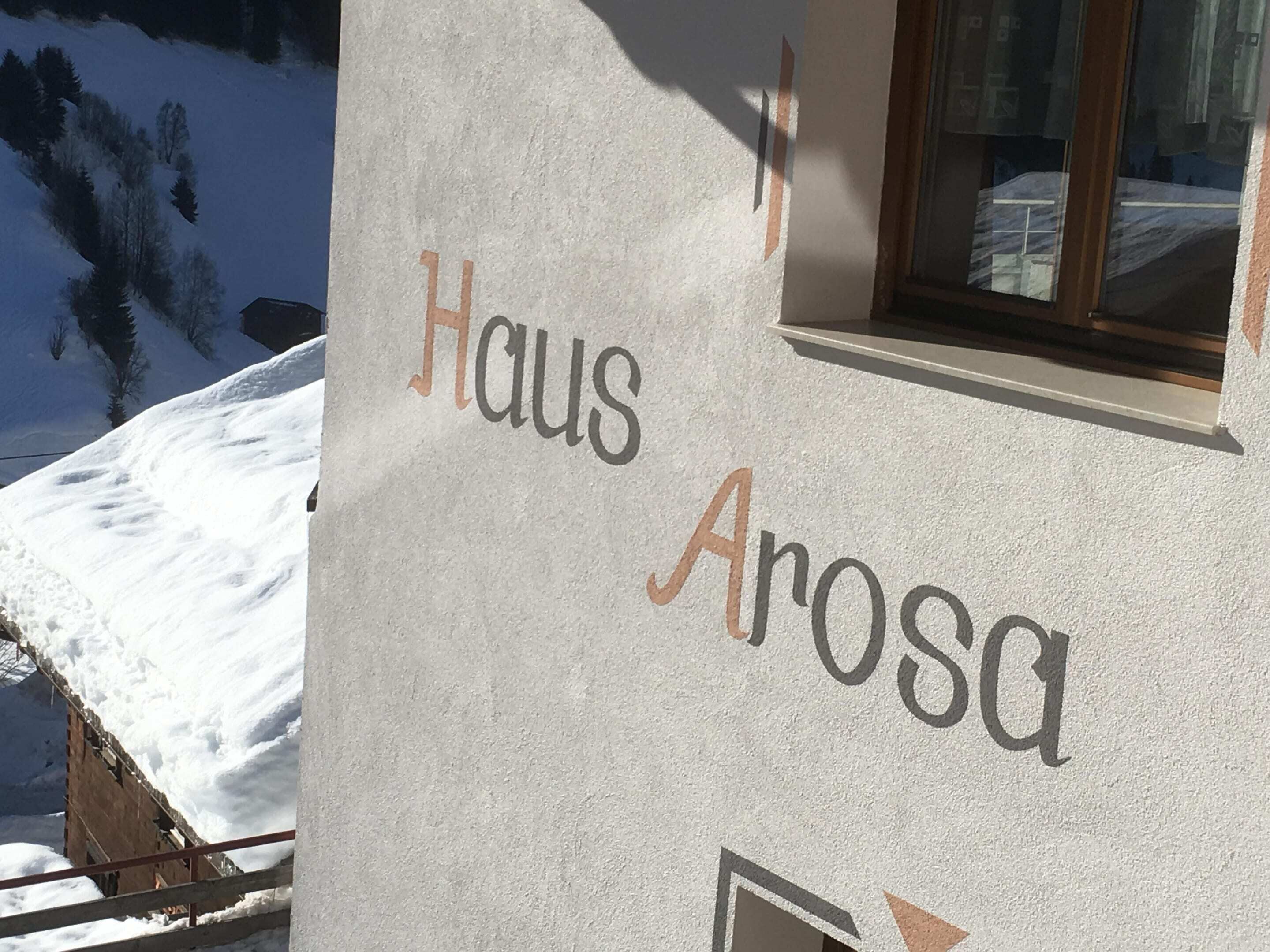 A building with the name 'Haus Arosa' written on its exterior wall.