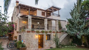 A two-story stone building with balconies, a staircase, and potted plants. - Villa for 8 Guests With Gorgeous View (Kissamos)