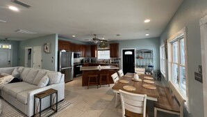 A spacious kitchen with a dining area, a built-in oven, and a ceiling fan. - Bayfront home with private pier & dock- near Fairhope & Magnolia Springs (Foley)