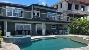 A modern two-story house with a swimming pool, outdoor seating, and a patio area. - Open water 3bdrm 3bath home with dock for 20 foot boat along with pool & jacuzzi (St. Petersburg)