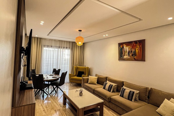 Relax in a bright, cozy living area with natural light and a large Smart TV.