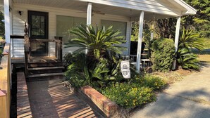 A house with a porch, steps, and a welcome sign.