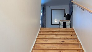 A wooden staircase leading to a room with a window and a desk. - Entire House. 2+ bed, 2 bath near Lake & bikeway (Burlington)