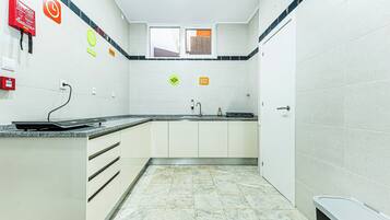 Full-size fridge, microwave, stovetop, cookware/dishes/utensils