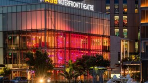 A modern building with a large glass facade and a sign reading 'ASB Waterfront Theatre'.
