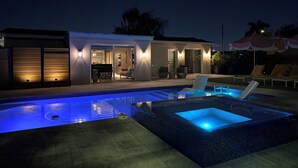 A modern house with a swimming pool, outdoor seating, and a well-lit entrance. - Casa Solea Miami • Pool Home w/ Workspaces + Master Office & Daybed (Miami)