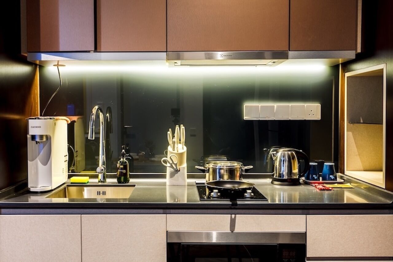 A modern kitchen with stainless steel appliances, a coffee machine, and a kettle.