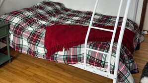 A bunk bed with a patterned bedspread and a red throw blanket. - Cozy 2-bedroom cabin in lovely Acra with cool AC (Acra)