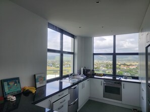 Panoramic Apartment, Ocean View | Private kitchen - U Suites at The Links (Paraparaumu)