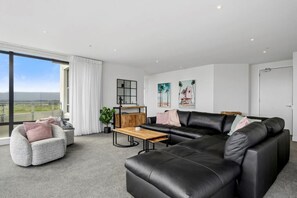Panoramic Apartment, Ocean View | Living area | Flat-screen TV - U Suites at The Links (Paraparaumu)