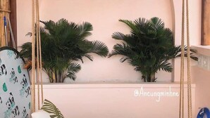 A cozy room with a swing bed, a wall with 'La Bonté' written on it, and hanging lanterns. - La Bonté Boutique Home Vung Tau (Ho Chi Minh City)
