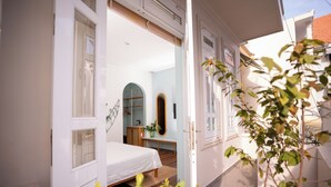 A bedroom with a bed, a dresser, and a mirror. - La Bonté Boutique Home Vung Tau (Ho Chi Minh City)