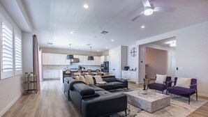 A modern living room with a sectional sofa, a coffee table, and two purple armchairs. - New Modern Luxury 8-bed mins to AAG, Fwy, Clubhouse. Ideal Sports or Ext Stay  (Mesa)