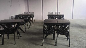 A room with four tables and chairs, arranged in a square pattern. - Hotel maa heritage (Jaipur)