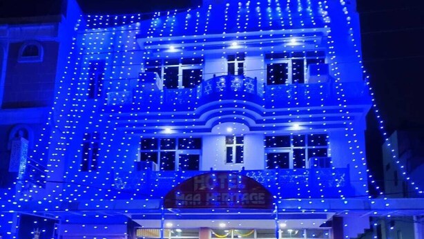 A hotel with a prominent entrance, a visible staircase leading to the entrance, and a sign indicating the hotel's name. - Hotel maa heritage (Jaipur)