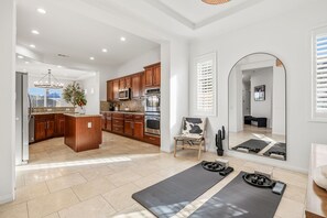 A spacious kitchen with wooden cabinets, a granite countertop, and a central island. - 4BR Indio Desert Escape • Stylish Stay • Mountain Views (Indio)