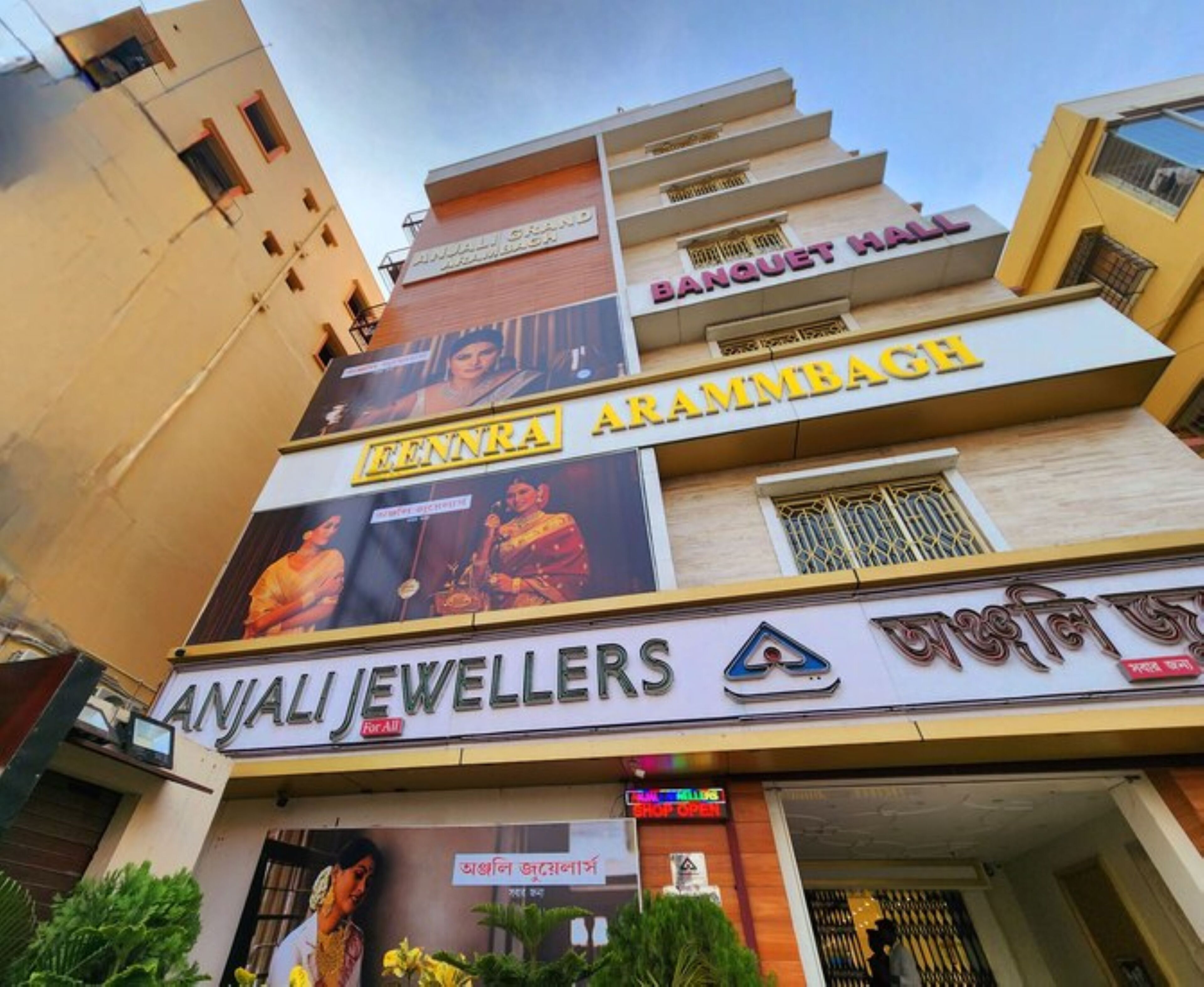 A multi-story building with a jewelry store named 'Anjali Jewellers' on the ground floor.
