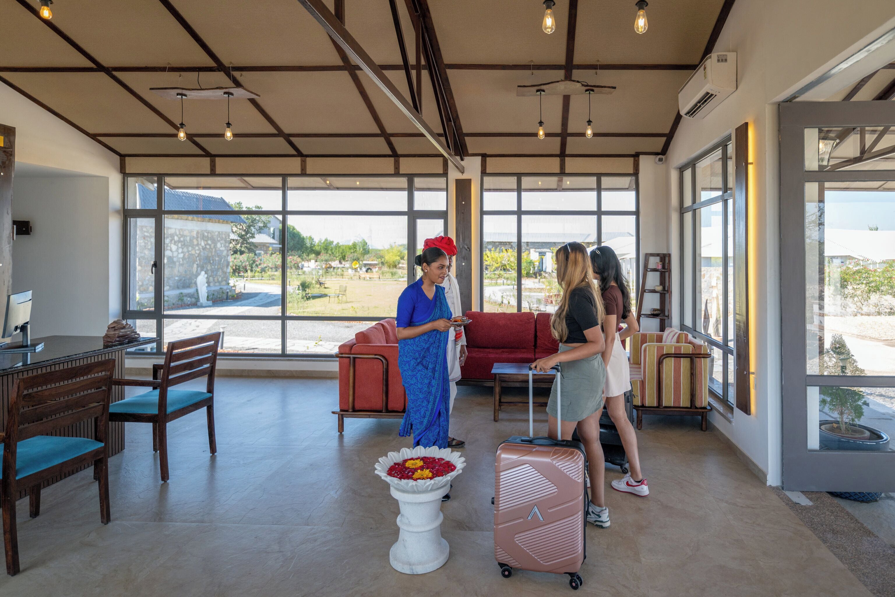 A spacious lobby with large windows, a reception desk, and a seating area.