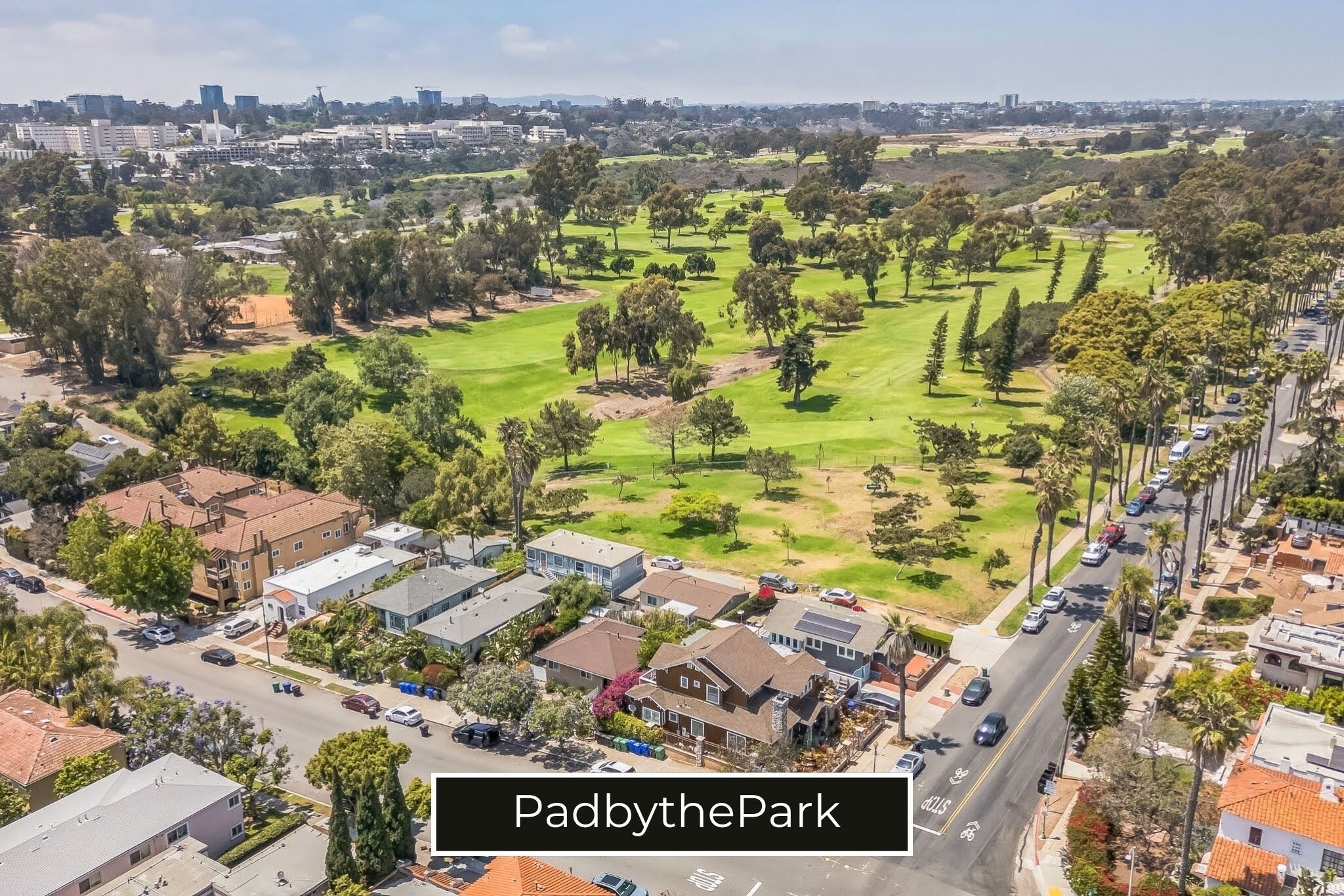 An aerial view of PadbythePark with residential buildings, roads, and green spaces.