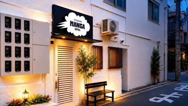 A building with a sign reading 'MANGA HOTEL,' a bench outside, and a row of lockers on the left. - Oyasumi manga hotel (Osaka)