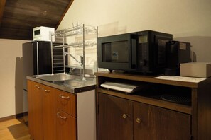 A kitchen with a refrigerator, microwave, and a sink. - Hotel Lighthouse Otaru (Otaru)