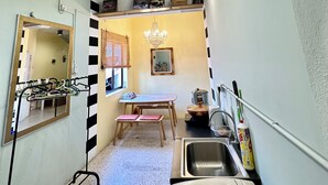 A compact kitchen with a sink, a microwave, and a small dining table. - Mac Inn 94 (George Town)