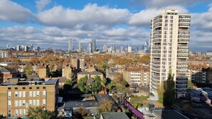 A high-rise building with a unique architectural design, surrounded by a mix of residential and commercial buildings in a cityscape. - Charming 2-bedroom Apartment in Central London (London)