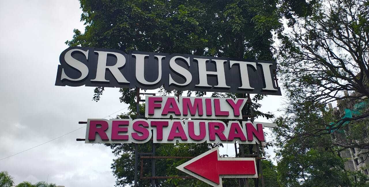 A sign for 'SRUSHTI FAMILY RESTAURANT' with an arrow pointing left.