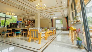 A spacious lobby with wooden furniture, a bar area, and large windows offering a view of the outdoors. - Harbor Diary Homestay (Xuancheng)