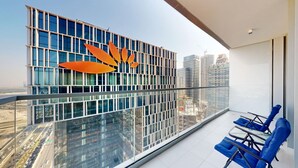 A modern building with a glass facade and a distinctive orange design element. - 2 Bed Direct Dubai Mall Access l Free Pool, Gym (Downtown Dubai)
