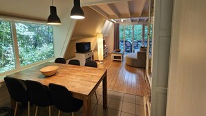 A modern interior with a wooden dining table, black chairs, and pendant lighting. - Nature Retreat Close to Durbuy Town (Durbuy)