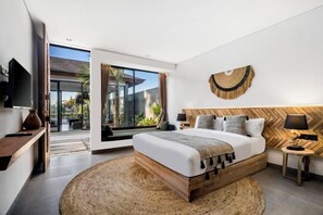A modern bedroom with a large bed, a TV, and a view of the outdoors. - Villa Mujo by BaliSuperHost (Bali)