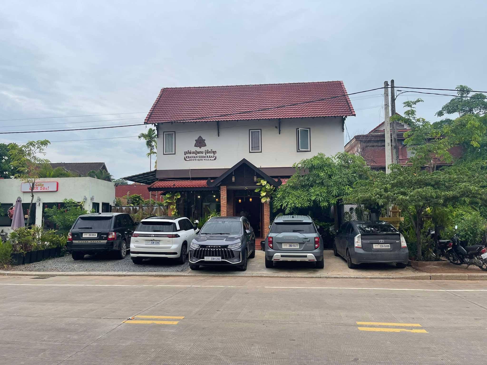 A building with a red-tiled roof and a sign indicating it is a boutique hotel.