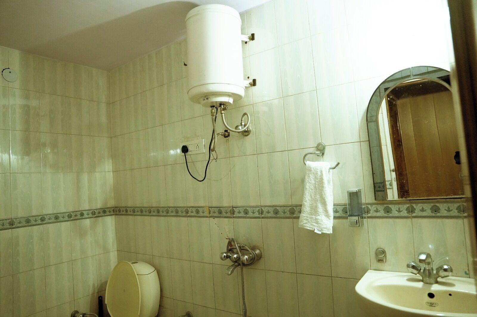 A bathroom with a toilet, sink, and shower.