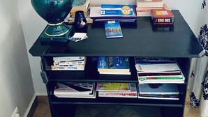 A study desk with a lamp, books, and a computer. - Riad Sahara Experience • Swimming pool (Souss-Massa Belfaa)