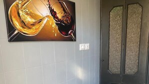 A modern room with a wooden table and black chairs, a dark door with frosted glass panels, and a large abstract painting on the wall. - La Mia Roma house-Charme Comfort & Relax-close subway-5 minutes from Colosseum (Roma)