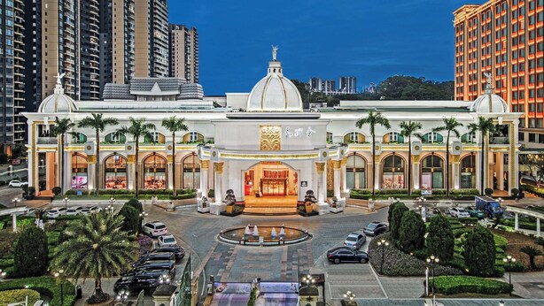 A grand hotel with a central dome, multiple arches, and a fountain in the courtyard. - Castfast Hotel (Dongguan)
