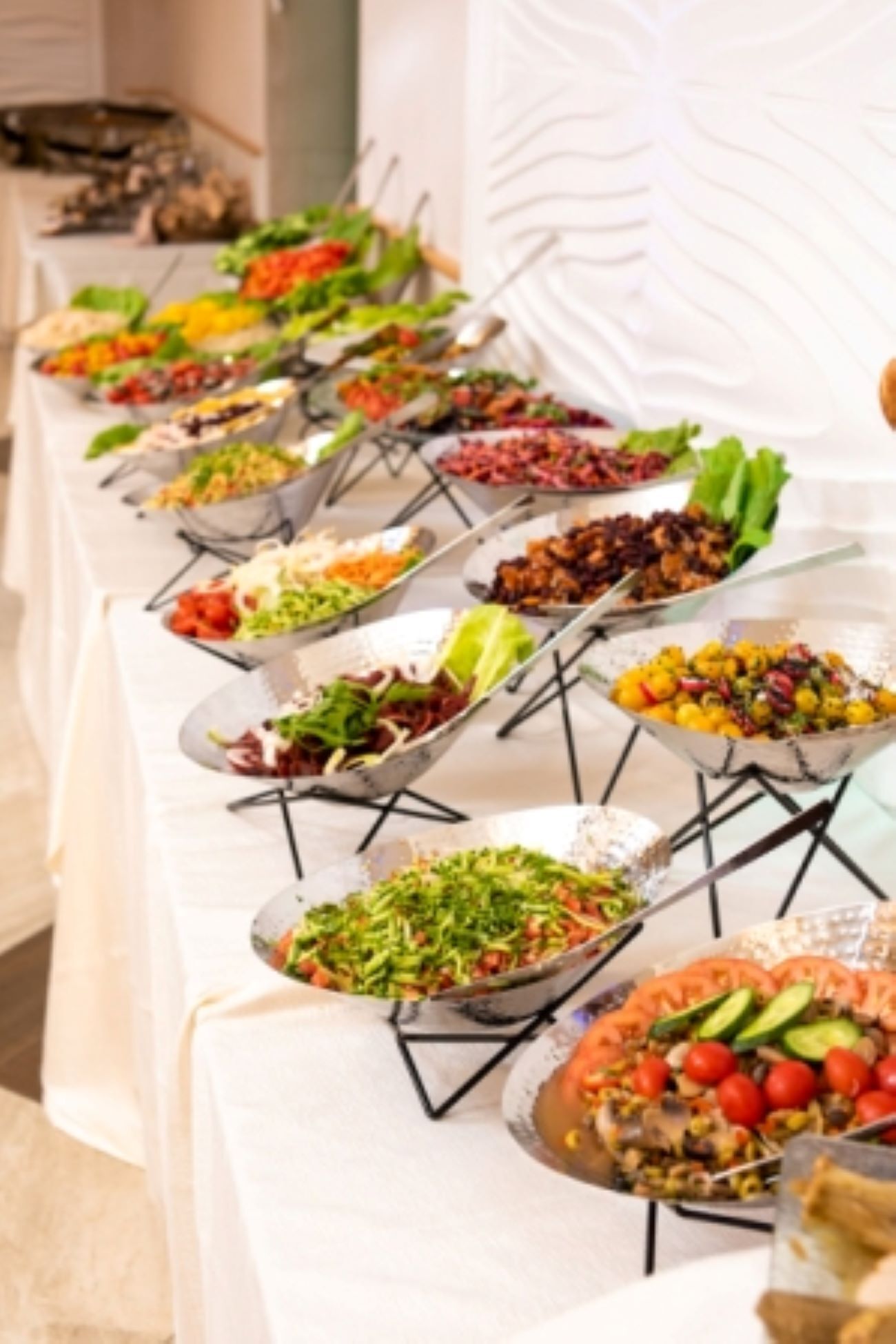 A buffet table with various dishes.