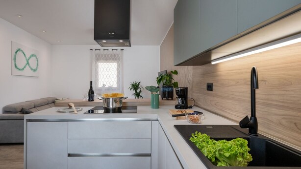 A modern kitchen with a central island, built-in appliances, and a minimalist design. - Kuca za odmor Hana by Villas Guide (Vodnjan)