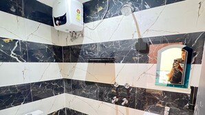 A bathroom with a toilet, sink, and shower. - Radhe Palace (Ayodhya)